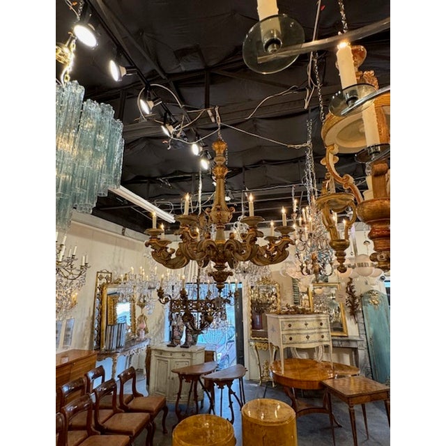 Gorgeous large scale 19th century French carved and parcel gilt wood chandelier. Circa 1880. The chandelier has been...