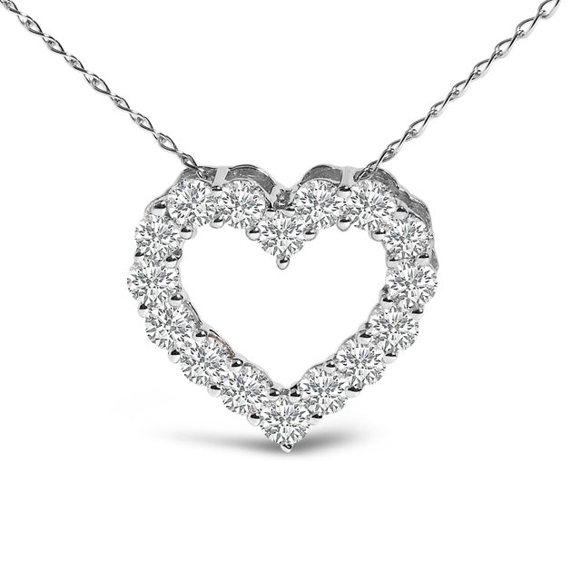 Cradled in the timeless embrace of 14K white gold, this heart-shaped pendant shines as a testament to love's unending...
