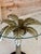A striking vintage sculptural palm tree side table attributed to Marge Carson, featuring a beautifully detailed gilt metal...