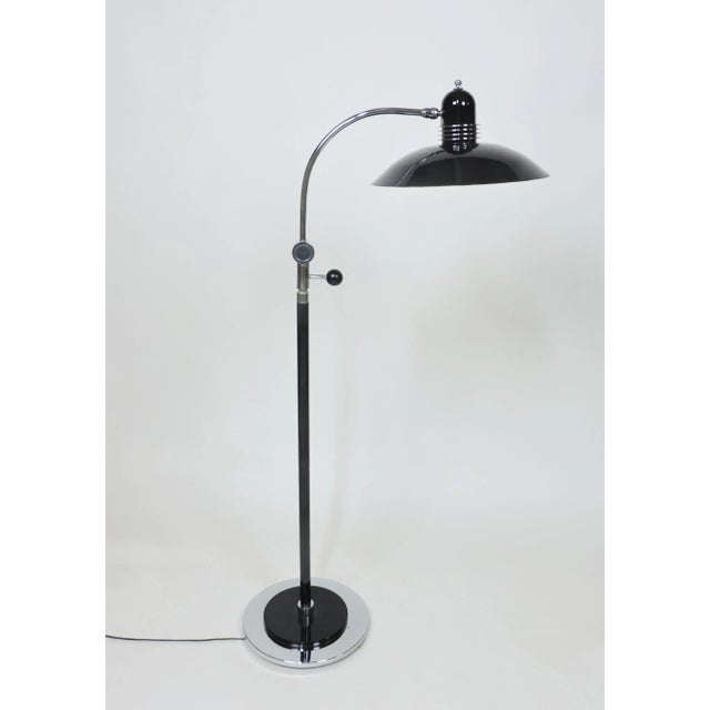 Beautiful Art Deco black and chrome floor lamp. The adjustable black enamel shade has four chrome discs for a very Deco...