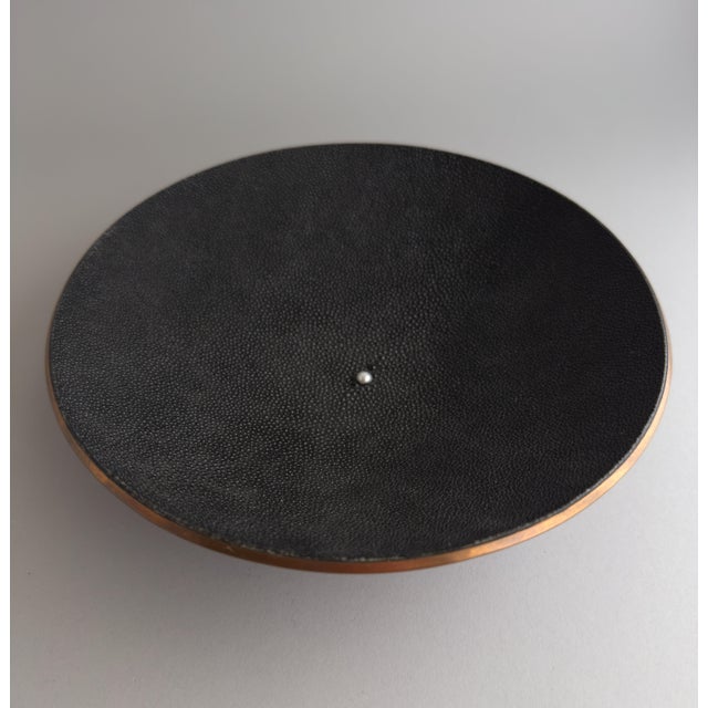 A striking low decorative bowl combining spun copper with a genuine black stingray shagreen interior. A single pearl is...