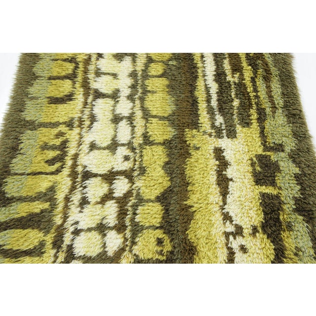 Hand-knotted in lush, high-pile wool in Sweden circa 1960-1970, this 3x6 vintage Swedish Rya runner rug is a bold new...