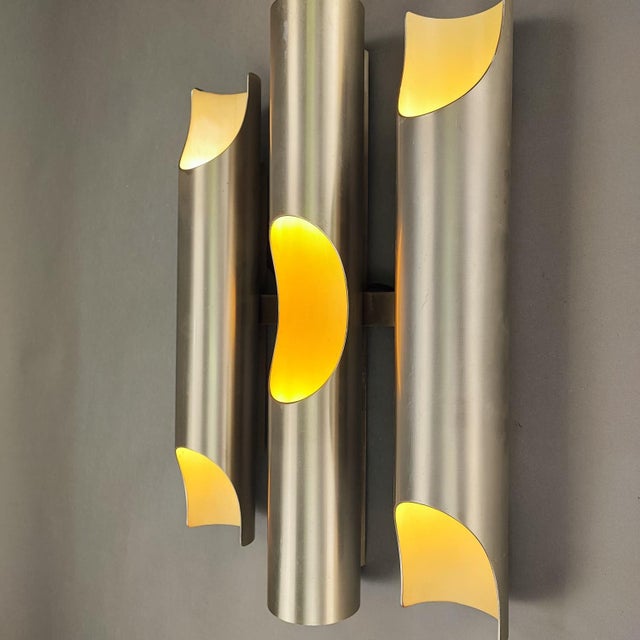 "Fuga" wall lamp by Maija Liisa Komulainen for Raak, designed in the 1960s. Made of brushed metal with a white interior....