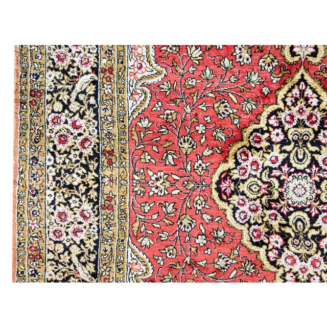 This exquisite vintage Persian Qum rug is hand-woven from 100% silk, offering a luxurious sheen and incredibly fine...