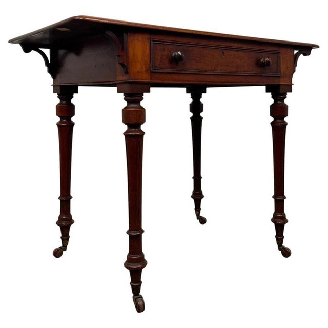 An elegant 19th-century English freestanding writing table, finely crafted from mahogany and distinguished by its finished...
