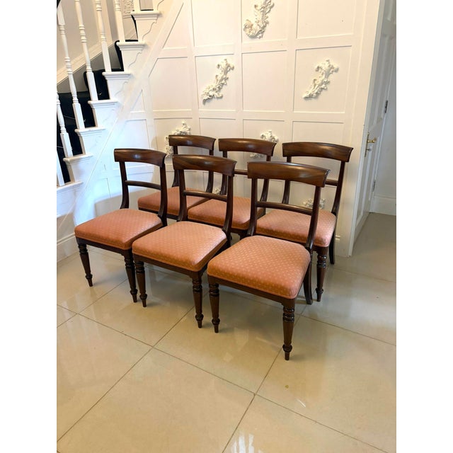 A fine set of six Regency mahogany dining chairs of elegant and refined form with gently curved bar backs and well shaped...
