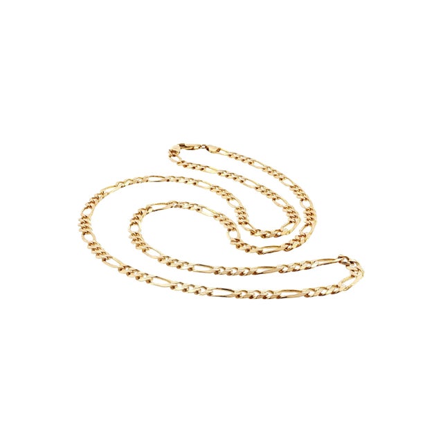A late 20th-century 14k gold 4.8mm 24" Figaro link chain necklace. The links alternate between short and elongated oval...
