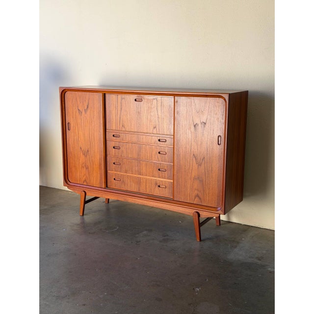 Danish teak sideboard from the 1960s, crafted in the style of H. P. Hansen. This elegant Mid-Century Modern cabinet...