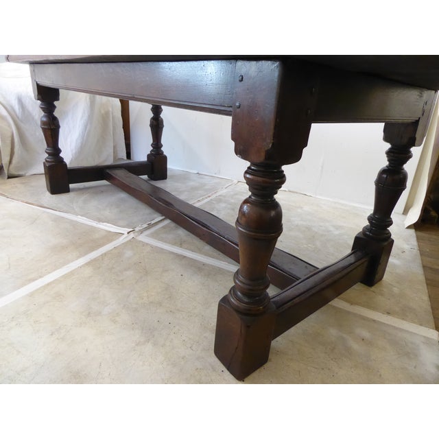 This sturdy oak Jacobean style dark oak heavy weight dining table measures 29.75"H x 96"L x 35.75"W and has a...
