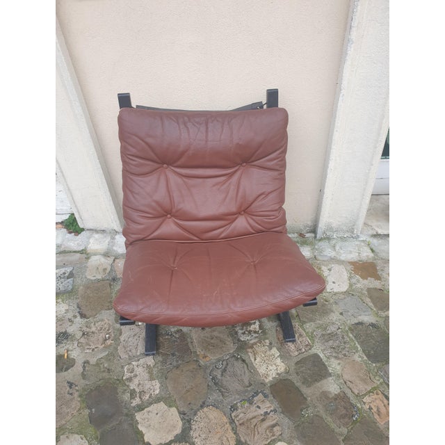 Vintage Norwegian ergonomic, very comfortable armchair in leather and curved wood.