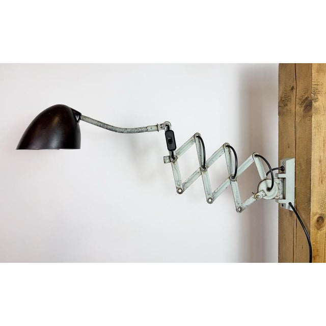 This vintage adjustable gooseneck industrial scissor wall light was produced by Elektroinstala in former Czechoslovakia...