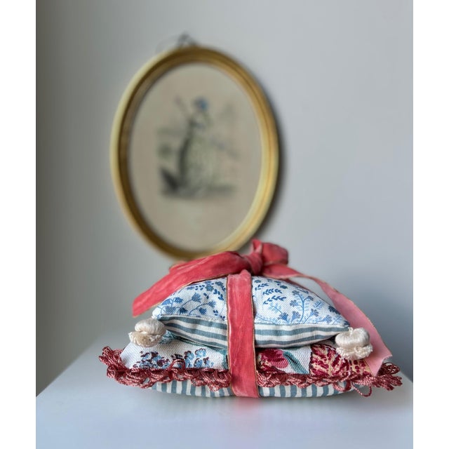A collection of two decorative pillows filled with fragrant dried lavender, one small and the other large. Pretty enough...