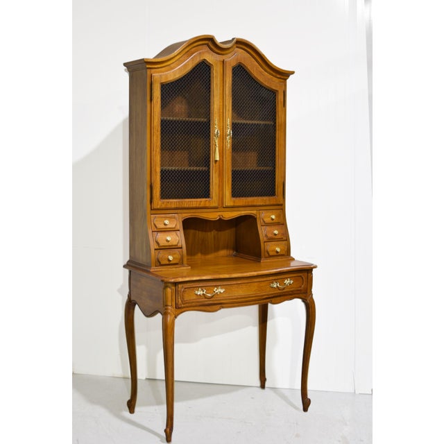 Vintage French Provincial secretary desk by Thomasville with a warm honey-brown wood finish, shaped cornice, and four...