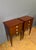 A pair of Louis XVI style bedside tables in mahogany marquetry with native wood stringing. They each have three drawers in...