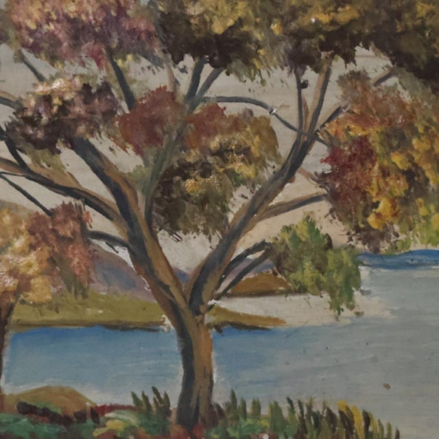 This mid-20th century French fall lake painting portrays a serene, seasonal landscape, where the rich tones of autumn...