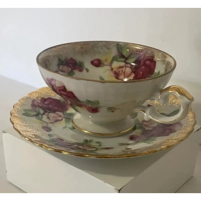 This beautiful vintage Royal Sealy Japan teacup and saucer set features lush multicolor roses in shades of burgundy, pink,...