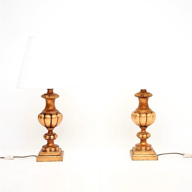 A bold and beautiful pair of antique French gilt wood table lamps, dating from around the 1950’s. They are of outstanding...