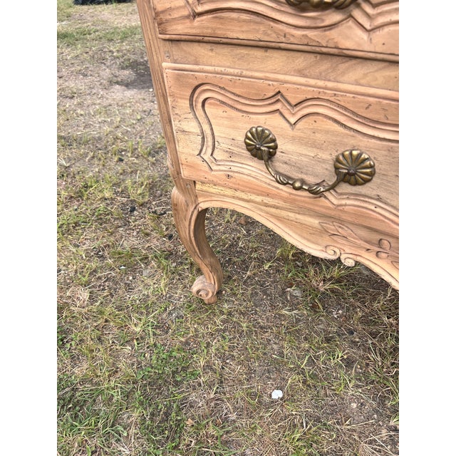 Charming Louis XV style commode featuring two spacious drawers, beautifully hand-carved details, and elegant cabriole...