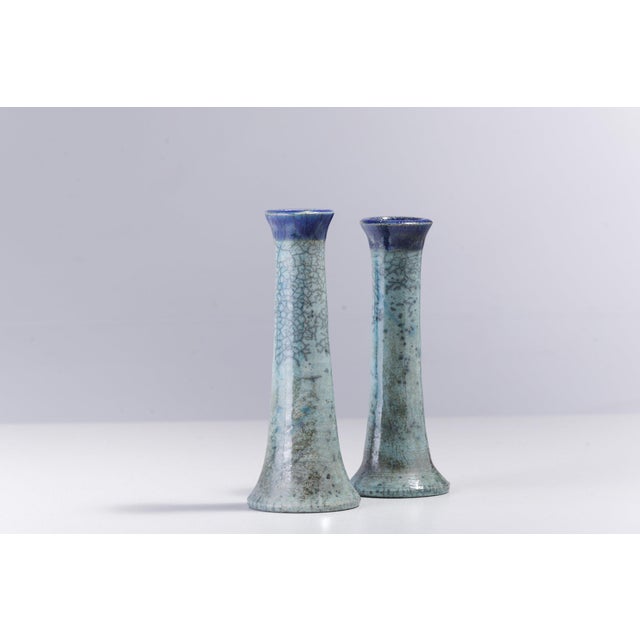 Captivating hues of bold visual impact make these two candle holders one-off pieces of unprecedented artistic charm....