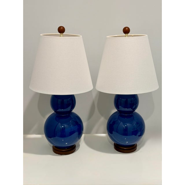 An elegant pair of authentic Ralph Lauren Home double gourd table lamps in a rich cobalt blue glazed porcelain finish....