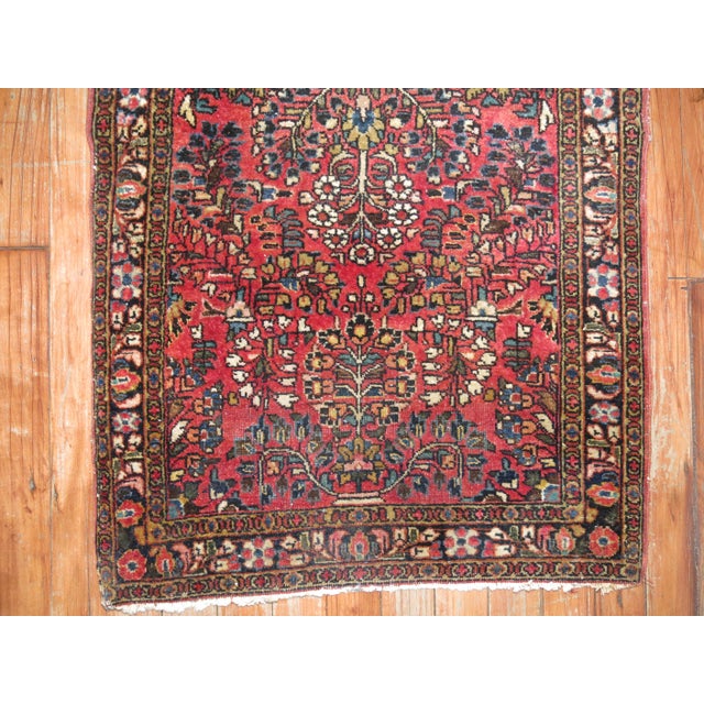 an early 20th century even medium pile condition traditional red and blue fine sarouk rug. Hand-woven, professionally...
