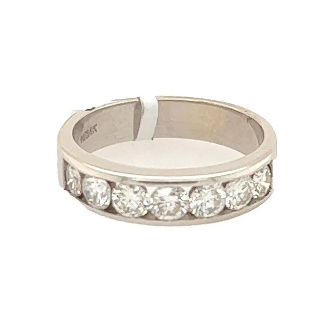 14k White gold band with 7 round diamonds weighing approximately 1/05 carats. 3.59 grams size 6