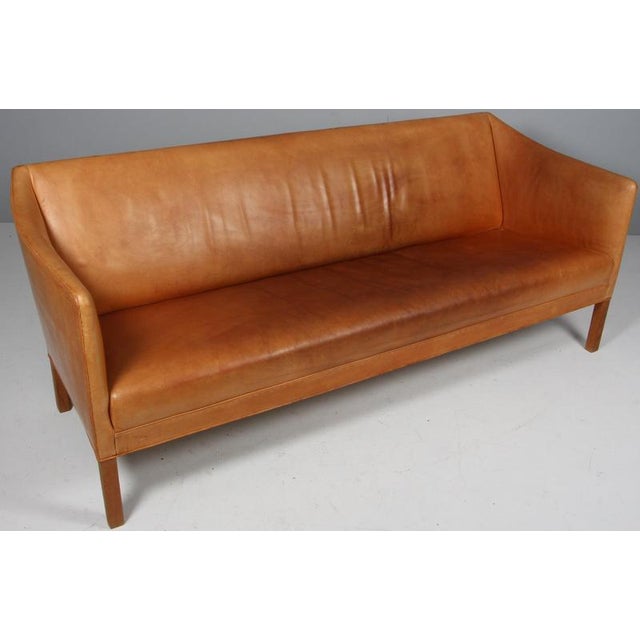 Ejner Larsen & Aksel Bender Madsen three seat sofa in original patinated nature leather. Legs of oak. Model Slotsholm This...