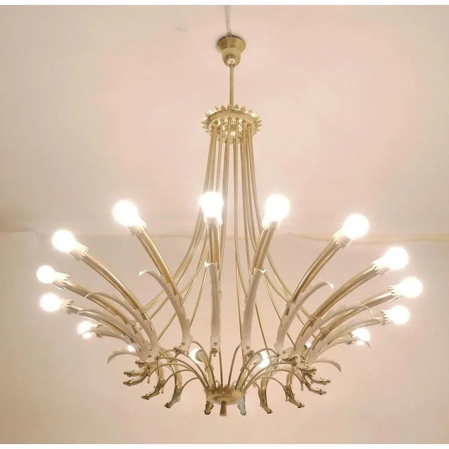 Italian chandelier in brass and lacquered metal with 16 lights. Made in Italy in the 1950s New electrical system with...