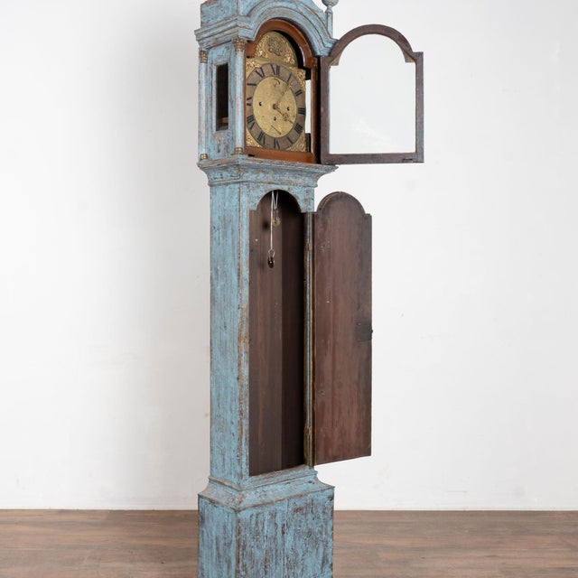 Early 19th century tall Swedish grandfather clock, crafted in pine. The (old but not original) blue painted finish has...
