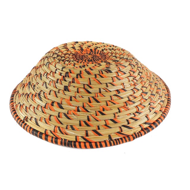 An open, coiled basket made from papyrus plants.Â The art of making baskets has become one of the most lucrative...