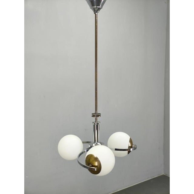 Exceptional Art Deco chandelier produced in Czechoslovakia during the 1930s. This elegant functionalist lighting fixture...