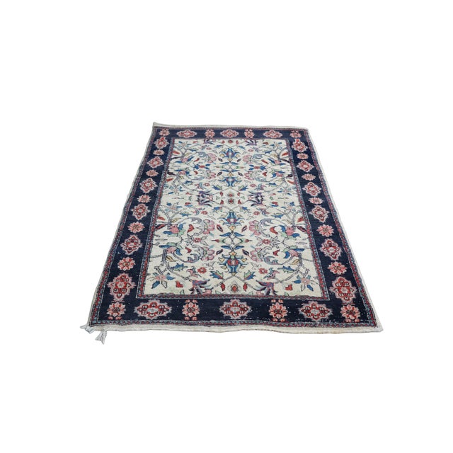 This vintage hand-knotted area rug showcases a remarkably refined Shah Abbas all-over floral layout measuring...