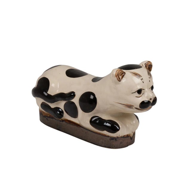 Cat in ceramic, rectangular in shape and white and black, spotted. Chinese work realized in the late 19th or early 20th...