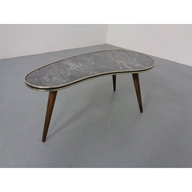 Three-legged kidney-shaped table from the 1960s.