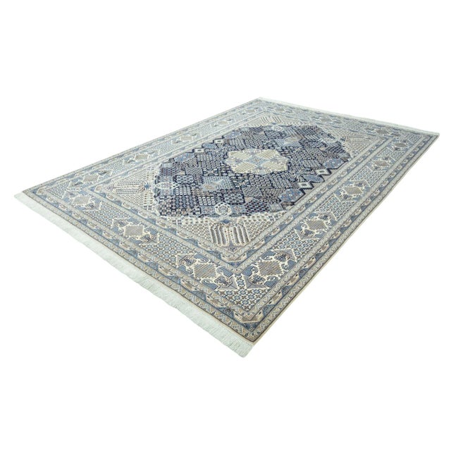 This exclusive hand-knotted Nain 9La oriental rug with silk content is a masterpiece of traditional rug craftsmanship....