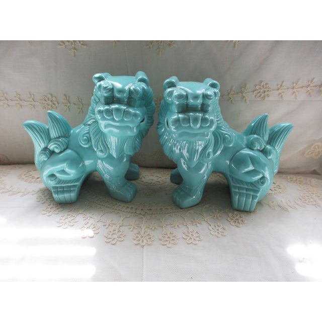 This is a pair of vintage turquoise Foo Lions figurines made of porcelain and pottery, originating from China in the...