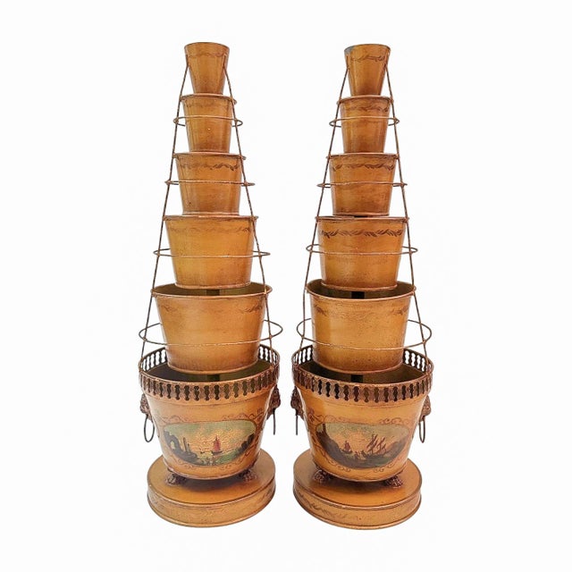 A striking pair of antique French Tole tulipieres featuring five graduated cups rising above large cachepot bases in an...