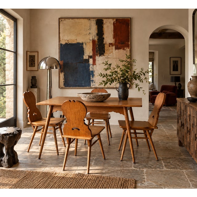 This vintage dining set pairs a rectangular oak table with four matching Stabelle chairs, both built on the same splayed,...