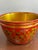Vintage hand-painted wooden bowl featuring bold red coloring with ornate gold and black folk art floral detailing. The...