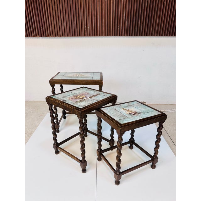 Elegant three-piece nesting table set of Scandinavian origin, made in Sweden around 1930. The decorative tabletops feature...