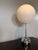 Light becomes sculpture. Robert Sonneman's iconic "Lollipop" lamp is a masterclass in restraint—pairing polished chrome...