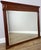 A characterful Antique French mirror featuring a substantial walnut frame, strong architectural lines and decorative...