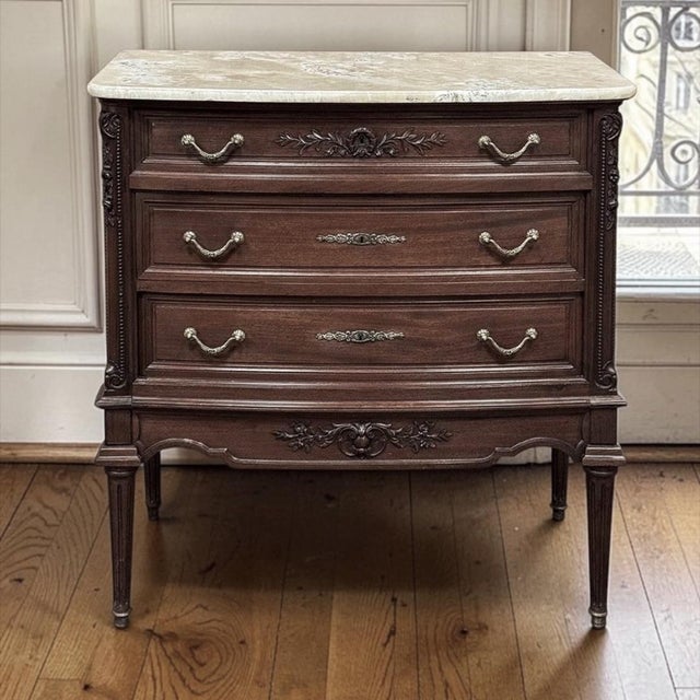 19th Century French Louis XVI Mahogany Onyx Top Commode represents a timeless expression of classical style that has...
