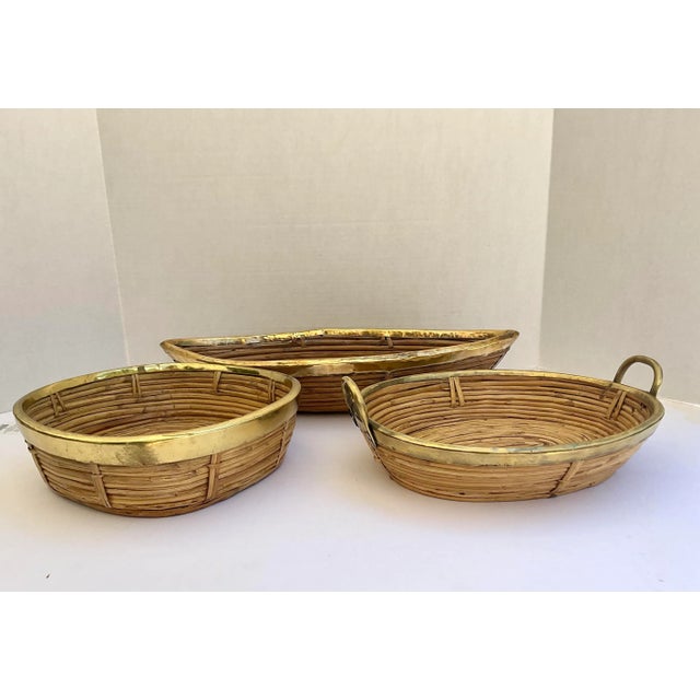 Just in this trio of 1970s Italian Brass & Rattan Bamboo Baskets.. Set of 3 low Brass and Pencil Bamboo baskets, from...