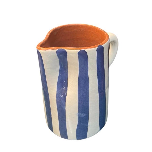 A ceramic pitcher Handcrafted and hand-painted by artisans in Marrakech, this piece features a timeless blue and white...