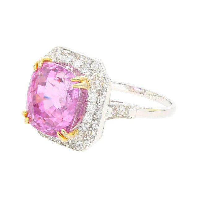 AGL certified 10.88 carat cushion cut pink sapphire & diamond halo ring. Adorned with 48 round diamonds around the main...