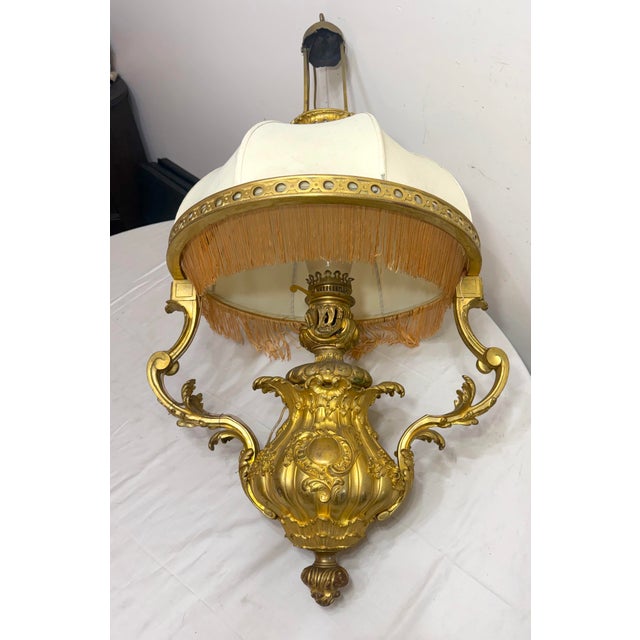Up for sale is a large antique 19th century ornate Louis XVI dore bronze electrified oil lamp chandelier. It exudes...