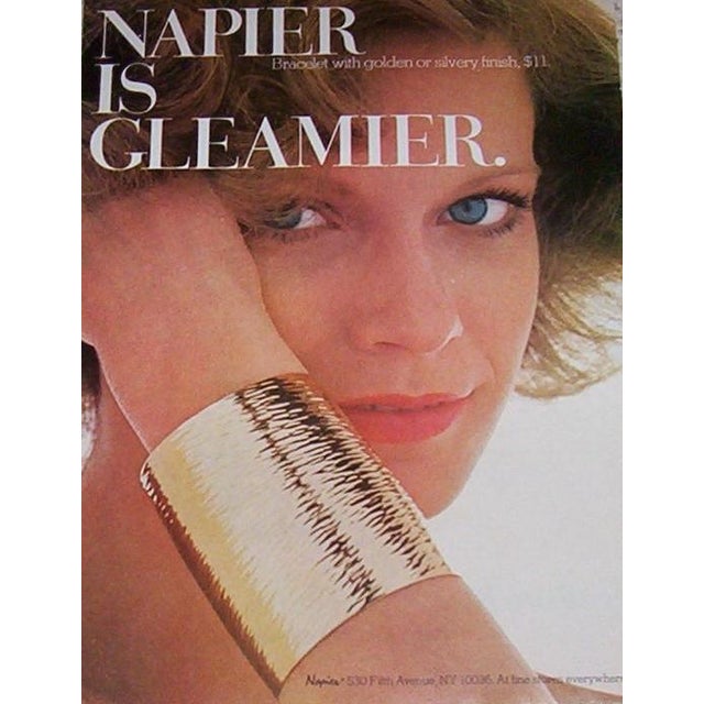 Rhodium plated wide wavy tapered slip on cuff bracelet. Marked "NAPIER©" on the inside middle along the edge. Measures: 2...