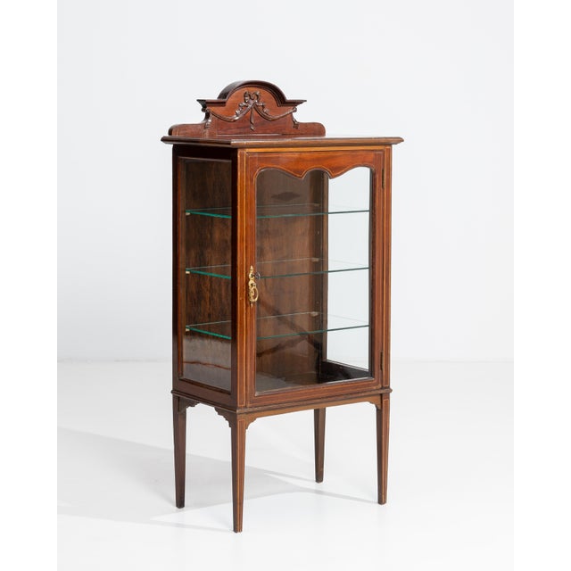 Crafted in England during the 19th century, this distinguished vitrine exemplifies the refined cabinetmaking traditions of...