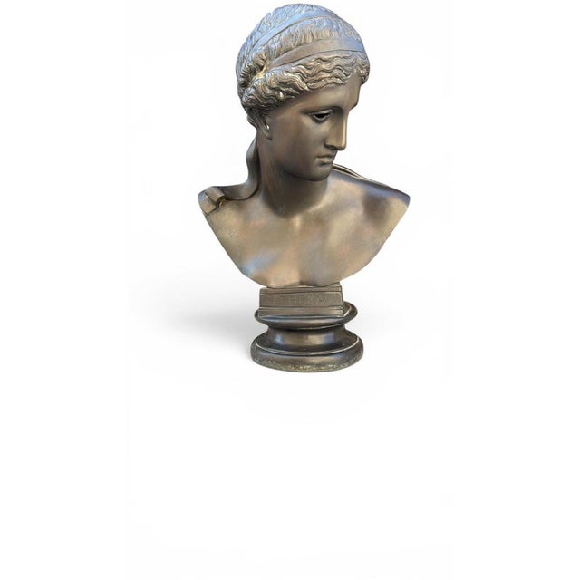 Impressive bronze bust depicting Athena, the revered goddess of wisdom, strategy, and warfare in Ancient Greek mythology....